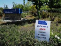 A sign placed by an activist, comments on how Lockheed Martin’s profits are derived from killings.