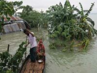 A family collects their goods before leaving their submerged home after flash floods at Goainghat sub-distric in Sylhet