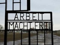 The gate at Sachsenhausen concentration camp, with the barren “parade ground” visible/Photo credit: Creative Commons image