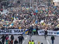 Thousands of demonstrators join Fridays for Future's global day of action to stand with Ukraine by walking down Willy-Brandt-Strasse, a main thoroughfare in Hamburg, Germany. (Photo: Daniel Reinhardt/dpa/picture alliance via Getty Images)