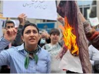 Demonstrators burn a scarf at a protest against the Iranian government on Sunday. (David Bates/CBC)