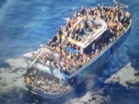 A handout image provided by Greece's coast guard on Wednesday, June 14, 2023, shows scores of people covering practically every free stretch of deck on a battered fishing boat that later capsized and sank off southern Greece. A fishing boat carrying migrants trying to reach Europe capsized and sank off Greece on Wednesday, authorities said, leaving at least 79 dead and many more missing in one of the worst disasters of its kind this year. [AP Photo/Hellenic Coast Guard via AP]
