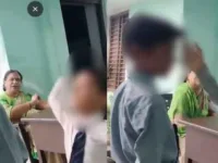 The students took turns slapping their fellow student even as the teacher watched on. (Screengrab)